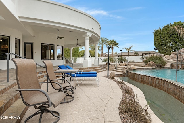 view of pool featuring pool water feature, ceiling fan, and a patio area