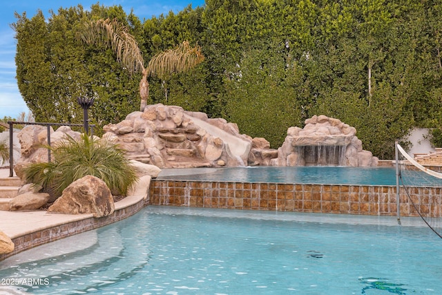 view of pool with pool water feature