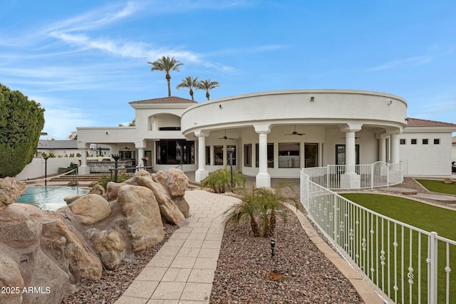 back of property featuring ceiling fan