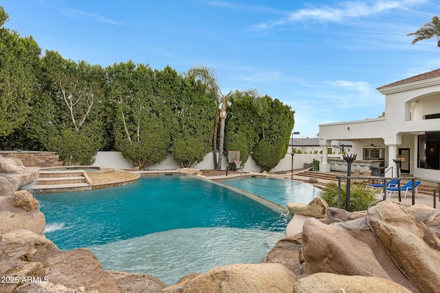 view of swimming pool with a patio, ceiling fan, and an in ground hot tub