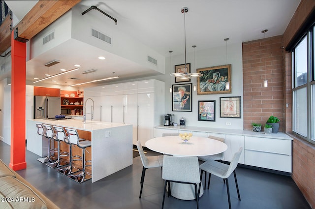 dining room with brick wall