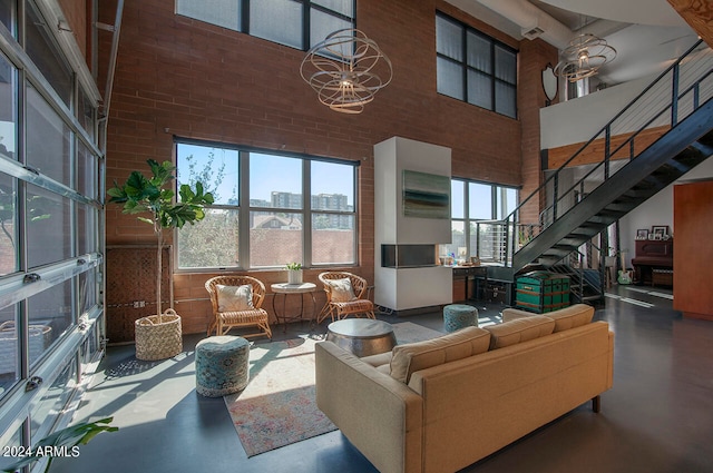 living room featuring a towering ceiling and concrete flooring