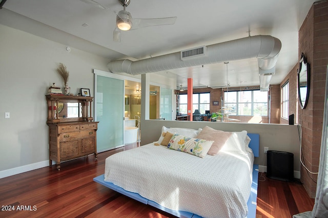 bedroom with ensuite bathroom, ceiling fan, and wood-type flooring