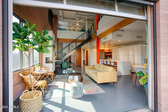 living room featuring concrete flooring and a healthy amount of sunlight