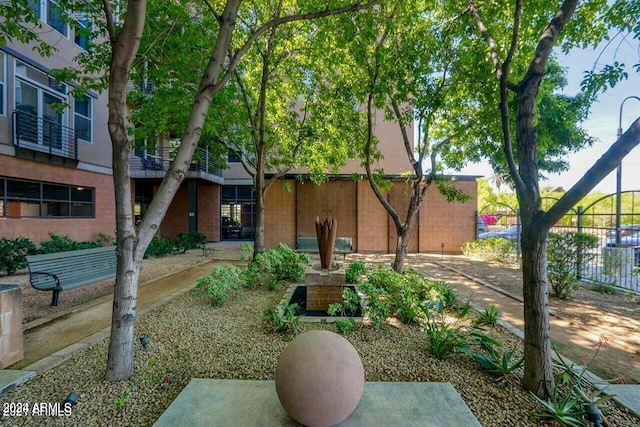 view of front of home featuring brick siding and fence