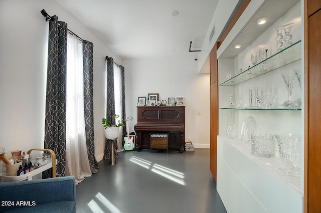 interior space with concrete floors, baseboards, and recessed lighting