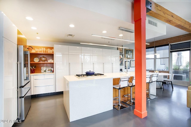 kitchen featuring modern cabinets, white cabinetry, and finished concrete flooring