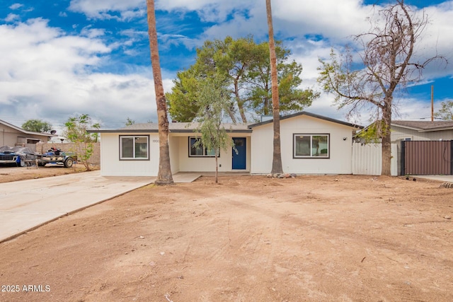 ranch-style home featuring fence