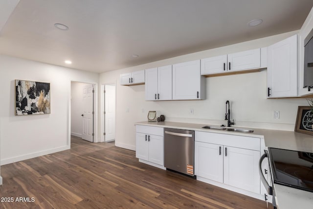 kitchen featuring dark wood-type flooring, a sink, stainless steel dishwasher, white cabinets, and light countertops