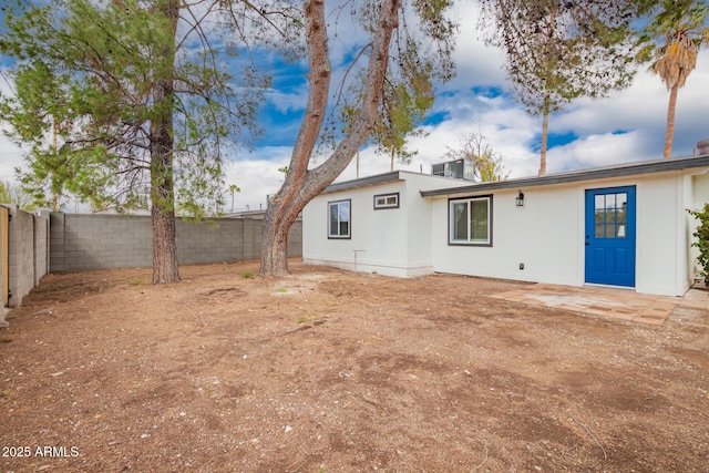 rear view of property featuring a fenced backyard