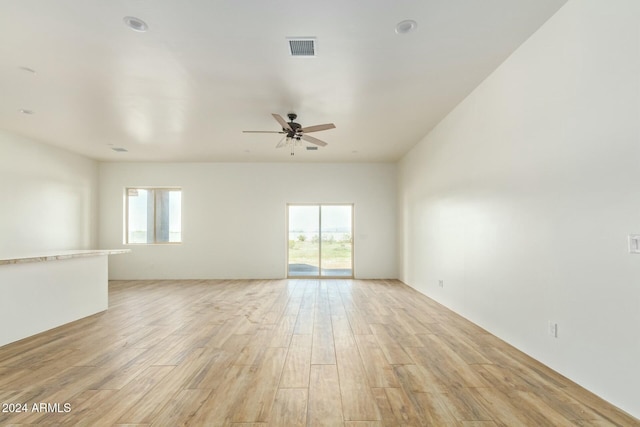 empty room with light hardwood / wood-style flooring and ceiling fan