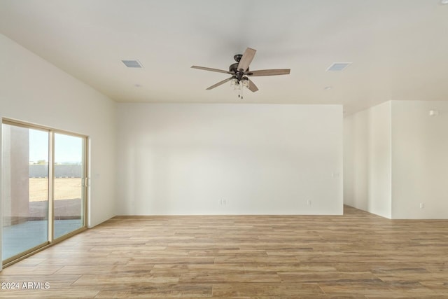 empty room with ceiling fan and light wood-type flooring