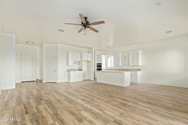 unfurnished living room with ceiling fan and light hardwood / wood-style flooring