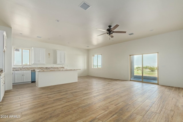 unfurnished living room with ceiling fan and light wood-type flooring