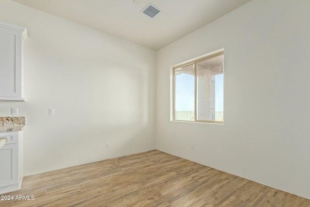 spare room featuring light hardwood / wood-style floors