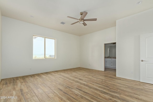 empty room with light hardwood / wood-style floors and ceiling fan