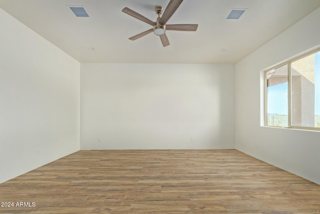 unfurnished room with ceiling fan and light wood-type flooring