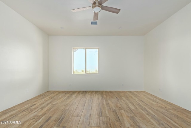 spare room featuring light hardwood / wood-style flooring and ceiling fan