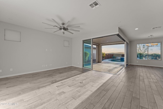 unfurnished living room with ceiling fan and light hardwood / wood-style floors