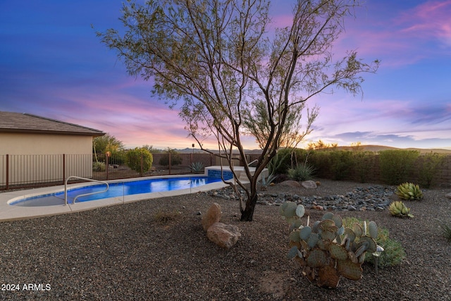 view of pool at dusk