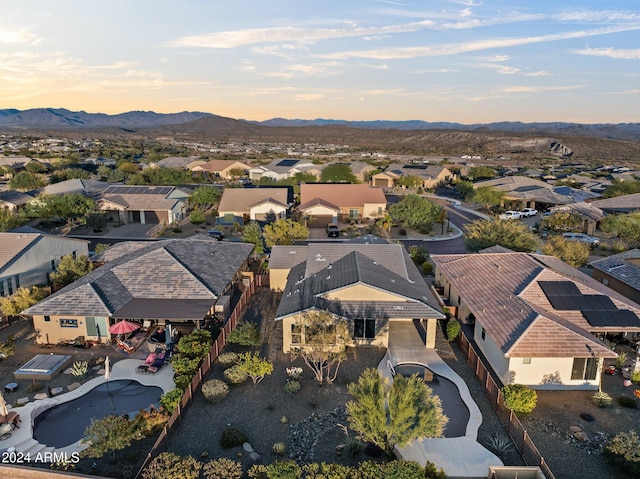 aerial view at dusk featuring a mountain view