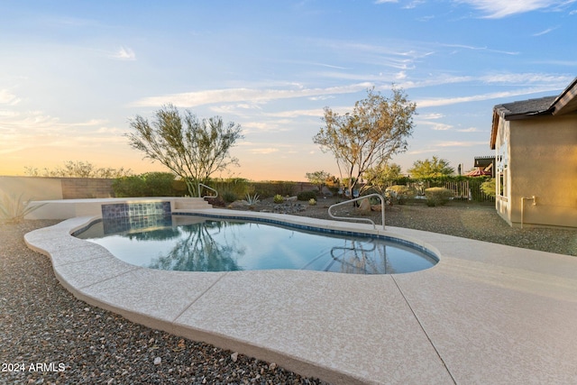 pool at dusk with a patio