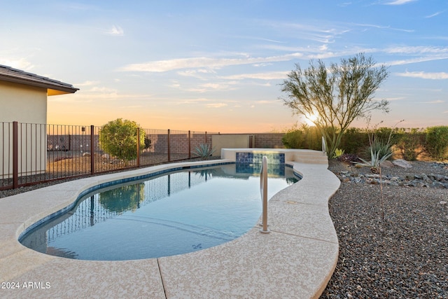 view of pool at dusk