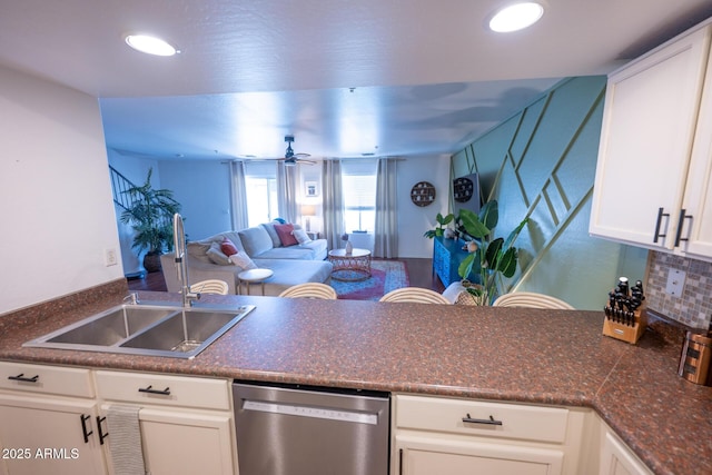 16021 N 30th St Unit 127, Phoenix, AZ 85032 - kitchen with stainless steel dishwasher, dark countertops, white cabinets, a peninsula, and recessed lighting