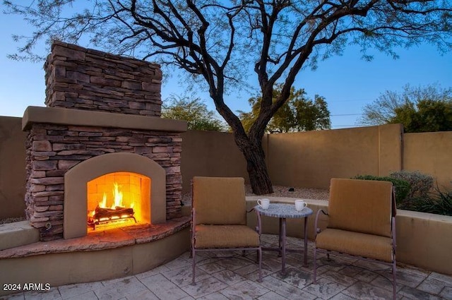 view of patio with an outdoor stone fireplace