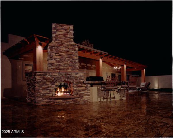 view of patio / terrace featuring a stone fireplace