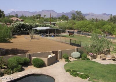 view of community featuring a mountain view and fence