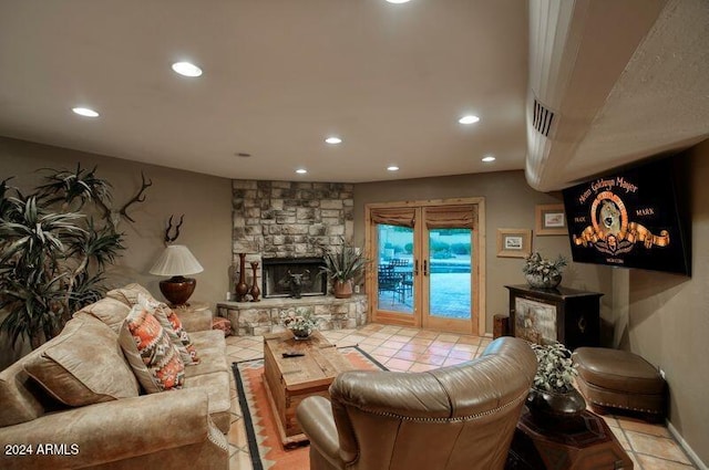 tiled living room with a fireplace and french doors