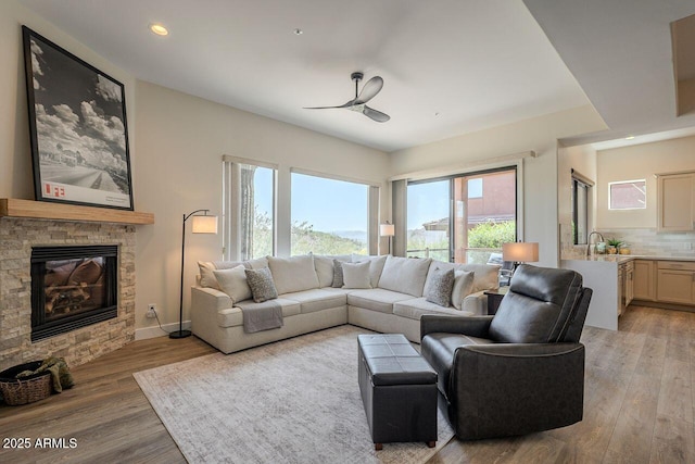 16248 E Ridgeline Dr, Fountain Hills, AZ 85268 - living area featuring recessed lighting, a stone fireplace, baseboards, light wood-style flooring, and ceiling fan