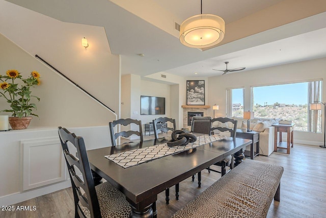 16248 E Ridgeline Dr, Fountain Hills, AZ 85268 - dining space with visible vents, wood finished floors, a fireplace, and ceiling fan