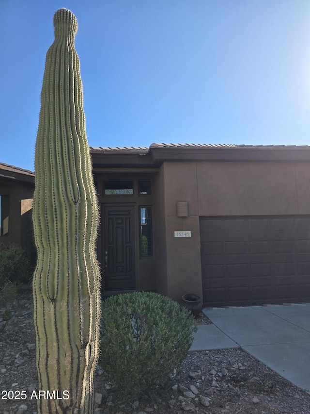 16248 E Ridgeline Dr, Fountain Hills, AZ 85268 - pueblo revival-style home featuring an attached garage, stucco siding, and concrete driveway