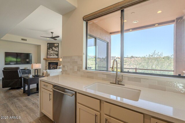 16248 E Ridgeline Dr, Fountain Hills, AZ 85268 - kitchen with light countertops, dishwasher, wood finished floors, a sink, and decorative backsplash