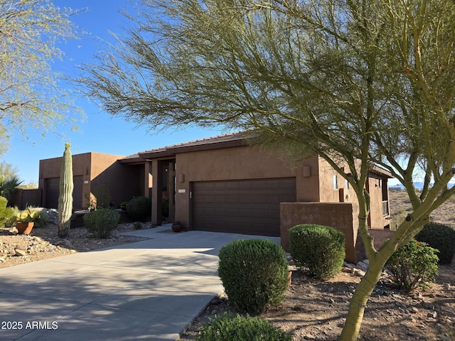 16248 E Ridgeline Dr, Fountain Hills, AZ 85268 - pueblo revival-style home featuring concrete driveway, an attached garage, and stucco siding