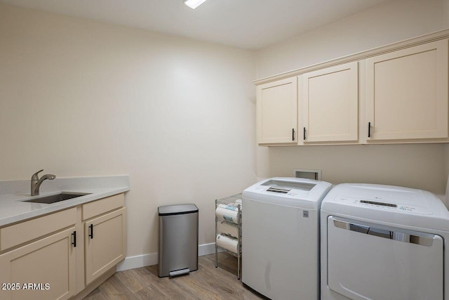 16248 E Ridgeline Dr, Fountain Hills, AZ 85268 - clothes washing area featuring washer and clothes dryer, a sink, light wood-style floors, baseboards, and cabinet space