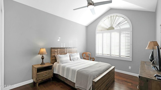 bedroom featuring multiple windows, ceiling fan, dark hardwood / wood-style flooring, and vaulted ceiling