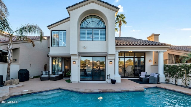 rear view of property with an outdoor hangout area and a patio area