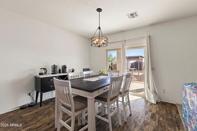 dining space featuring a chandelier, visible vents, dark wood-type flooring, and baseboards