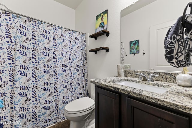 bathroom featuring curtained shower, toilet, and vanity