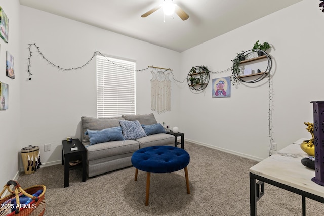 living room with baseboards, carpet floors, and a ceiling fan