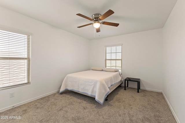carpeted bedroom featuring ceiling fan and baseboards