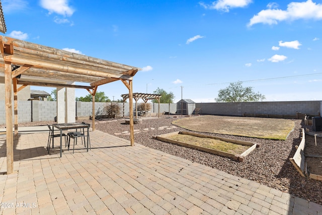 view of patio with an outdoor structure, a storage unit, a fenced backyard, and a pergola