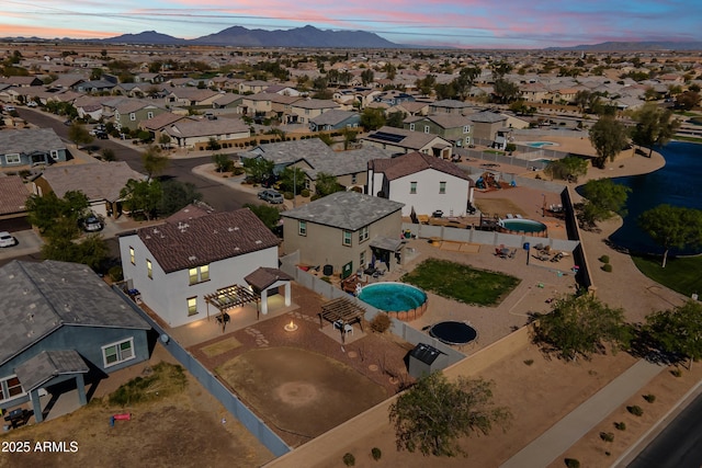aerial view at dusk with a mountain view and a residential view