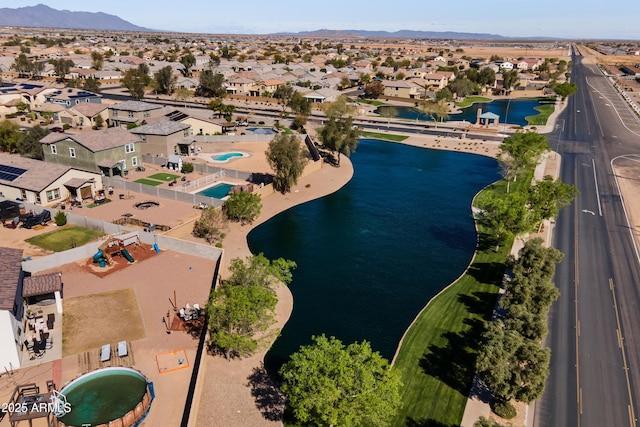 drone / aerial view with a residential view and a water and mountain view