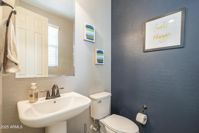 bathroom with sink and toilet