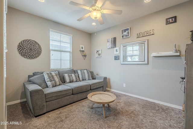 carpeted living room with ceiling fan