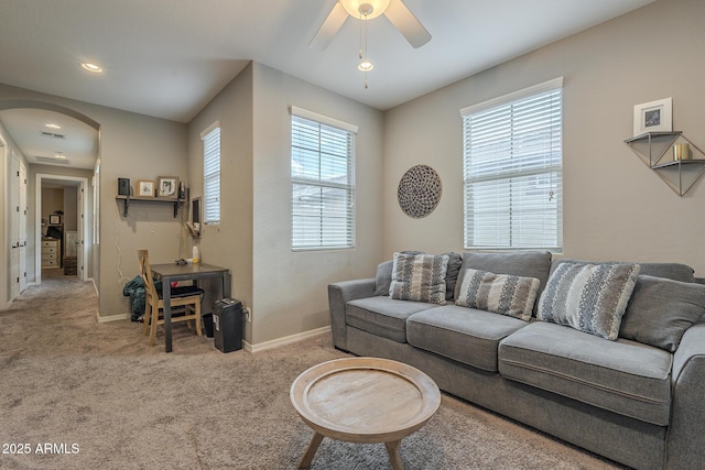 living room featuring ceiling fan and carpet